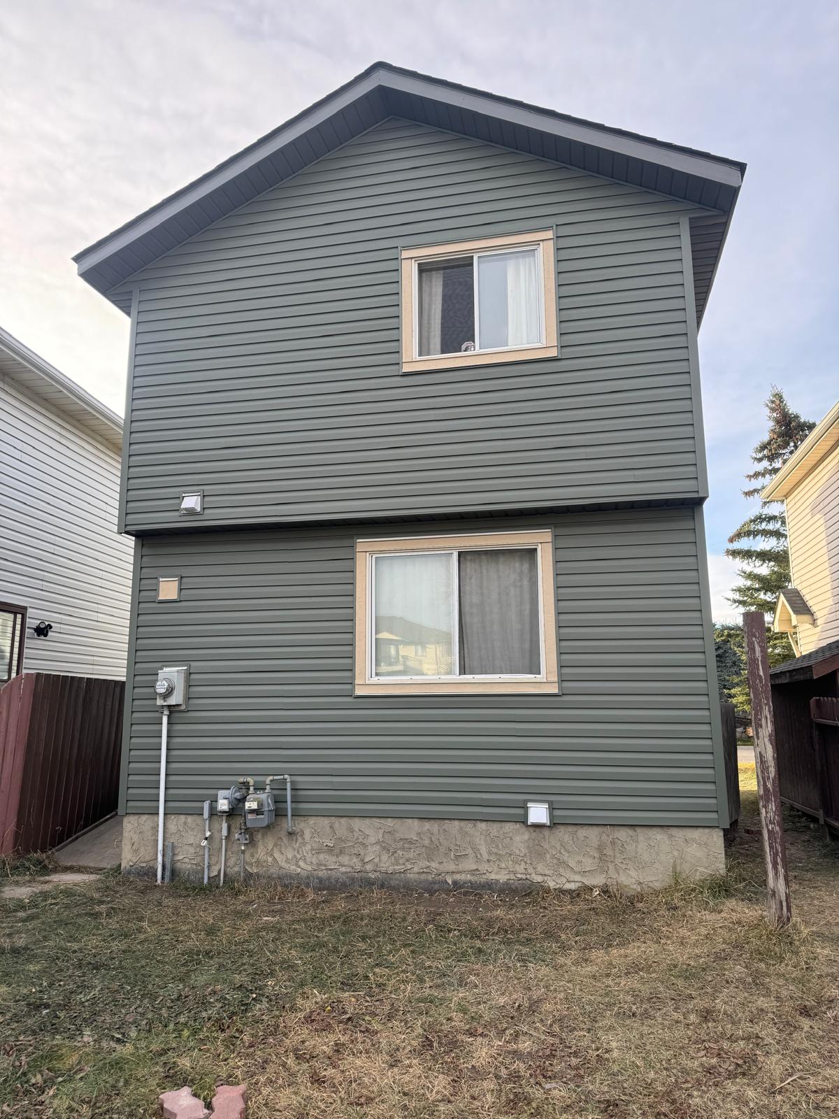 Professional siding contractors installing James Hardie boards in Calgary