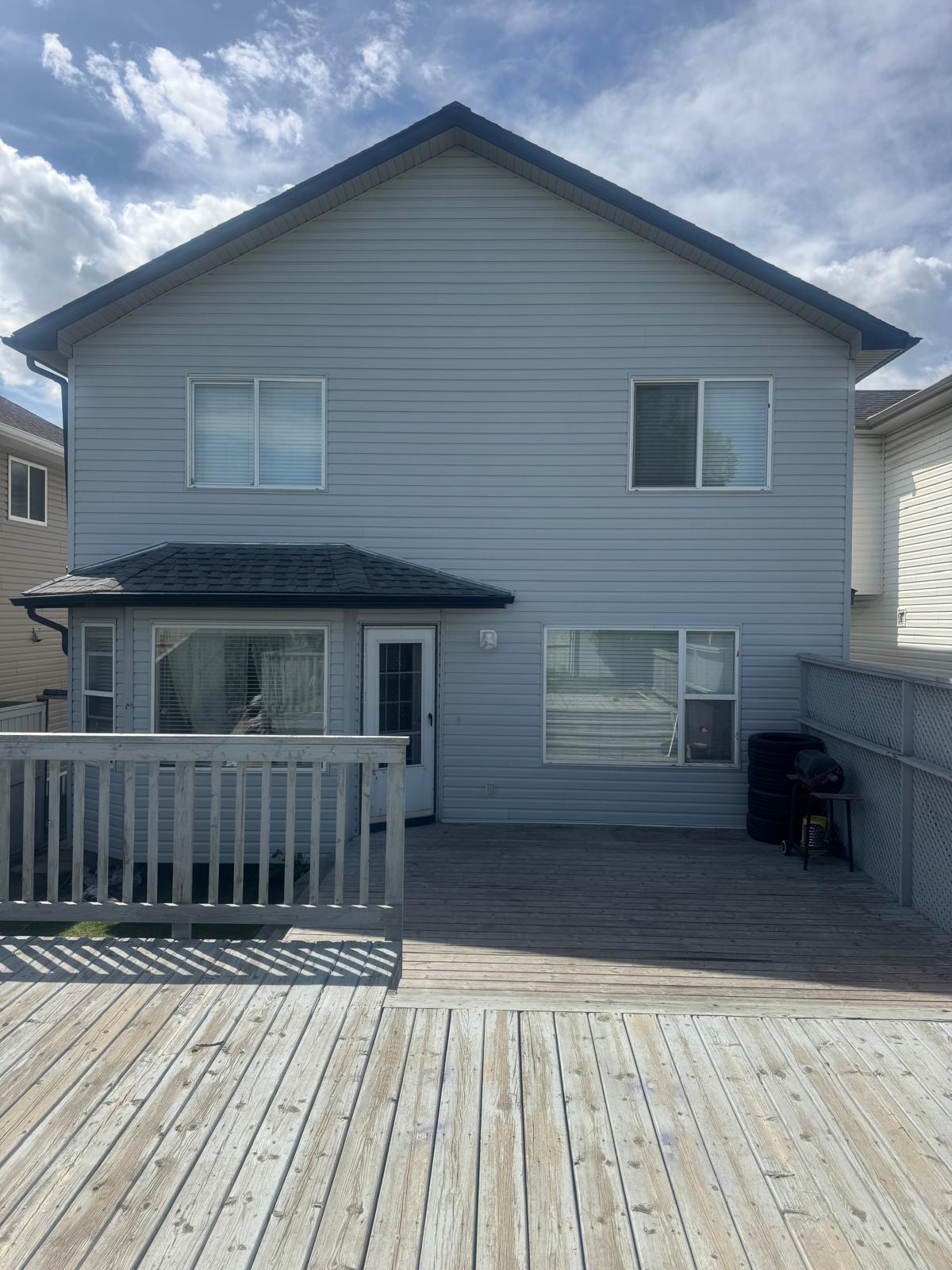 Modern home in Calgary with a mix of dark siding and wood panels