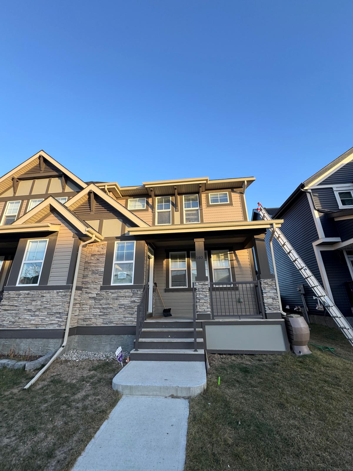 A beautiful two-story house in Calgary with light grey vinyl siding